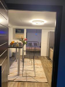 a kitchen and dining room with a table and chairs at Le Clos de Bourgueil in Sainte-Anne