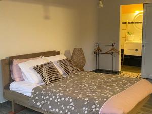 a bedroom with a bed with pillows on it at Le Clos de Bourgueil in Sainte-Anne