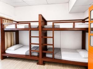 a bunk bed room with three bunk beds in it at Sunset Seaview Bay Villa in Putatan