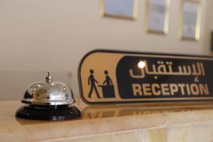a sign sitting on top of a counter next to at Terrace Alzahra تيراس الزهرا in Jeddah