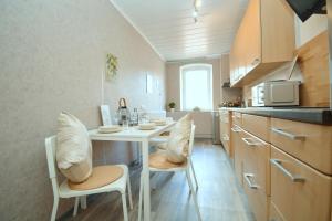 a kitchen with a table and chairs in a kitchen at Apartments in Ebrach am Kloster in Ebrach