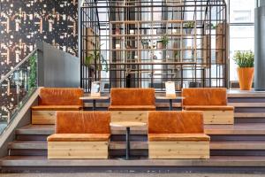a group of chairs sitting on steps in a building at Comfort Hotel Union Brygge in Drammen