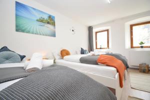 a room with three beds and a tv on the wall at Apartments in Ebrach am Kloster in Ebrach