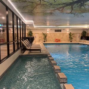 a large swimming pool in a hotel with a pool at Nuremore Estate in Carrickmacross