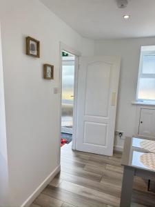 a room with a white door and a table at Altons Bothy Guest House in Kinmuck +29 photos