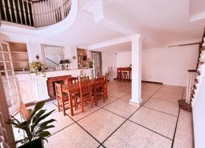 a kitchen and dining room with a table and chairs at OLO Hostel Boutique & Bar Club SANTA FE in Santa Fe