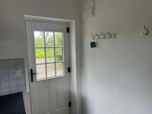 a white door in a room with a window at The Studio in Willerby