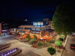 a view of a city at night at Hotel Park in Široki Brijeg