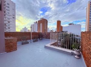 a balcony with a view of a city skyline at OLO Hostel Boutique & Bar Club SANTA FE in Santa Fe