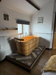 a wooden bath tub sitting in a room at The Stables in Llandysul