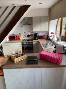 a kitchen with a counter top with a sink and a counter sidx sidx at The Stables in Llandysul