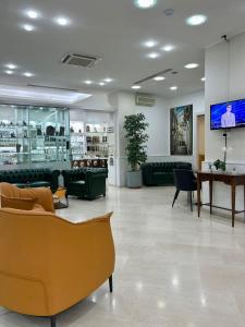 a lobby with couches and a tv on a wall at Hotel Pace in San Giovanni Rotondo
