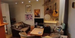 a living room with a couch and a table at B2B Apartment Creamundi in Lokeren