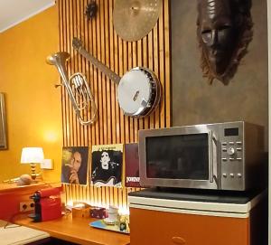 a microwave sitting on top of a wooden desk at B2B Apartment Creamundi in Lokeren +9 photos