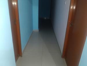 a hallway with two doors and a white floor at crown crest condos in Chengalpattu
