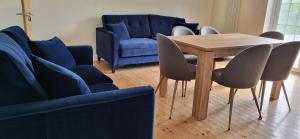 a dining room with a wooden table and chairs at Ox Mountain View 3 Bed apartment in Foxford