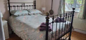 a bedroom with a bed with a metal frame at Ox Mountain View 3 Bed apartment in Foxford