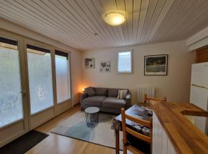 a living room with a couch and a table at Gîte Le Devant De La Chaux in Pontaix