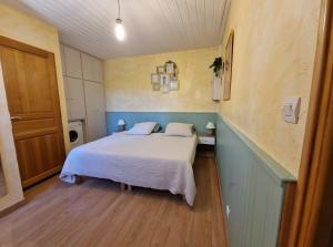 a bedroom with a white bed with two pillows at Gîte Le Devant De La Chaux in Pontaix +22 photos