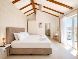 a bedroom with a bed and a large window at Orebic Luxury Villa Leopold in Orebić