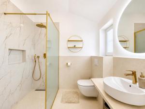 a bathroom with a sink and a toilet and a shower at Orebic Luxury Villa Leopold in Orebić