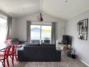 a living room with a couch and a table at Natuurhuisje Abcoude - De Smient - Best Family Stay in Abcoude