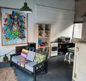 a living room with a couch and a painting on the wall at LodelaAbuela 3 in Ciudadela