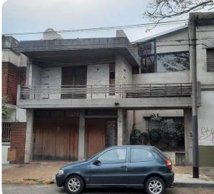 a blue car parked in front of a building at LodelaAbuela 3 in Ciudadela +6 photos