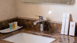 a bathroom counter with a sink and a faucet at Terrace Alzahra تيراس الزهرا in Jeddah +6 photos