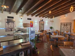 a restaurant with tables and chairs in a room at La Locanda del Gusto in Cadro