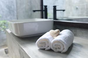a bathroom counter with towels and a sink at Aji fruit farm cottage peaceful lakeside farm stay with sunrise views 03 in Embilipitiya +45 photos