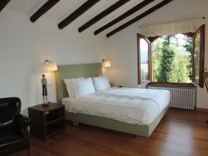 a bedroom with a large bed and a window at The Golf Club Guest House in Menaggio
