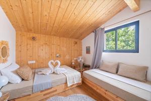 a bedroom with two beds and a wooden ceiling at Villa typique - piscine et terrasse in La Teste-de-Buch +22 photos