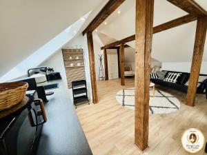 a living room with wooden beams in a loft at Parkresidenz Viktoria Luise in Bad Salzuflen