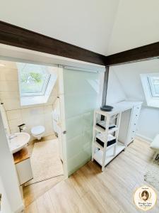 a small bathroom with a toilet and a sink at Parkresidenz Viktoria Luise in Bad Salzuflen +64 photos