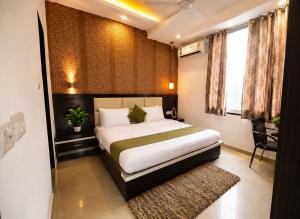 a bedroom with a large bed in a room at Hotel Embassy Star Taaj Agra - Budget Ac Rooms Near Taj in Agra