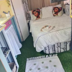 two dolls laying on a bed in a room at The Clarevan in Clarens