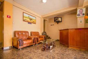 a waiting room with leather furniture and a podium at Eland Safari Hotel Nyeri in Nyeri