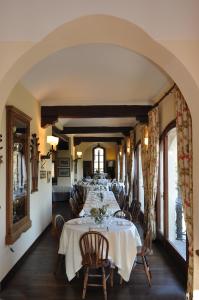 a dining room with a long table and chairs at The Golf Club Guest House in Menaggio