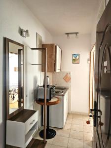 a small kitchen with a stove and a refrigerator at Apartmani Banić Apartman Studio 3 in Postira