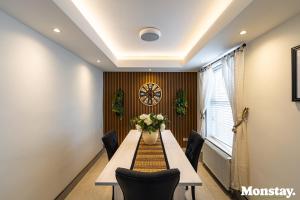a dining room with a long table and chairs at Walled City House in Derry Londonderry