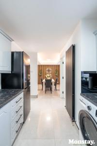 a kitchen with white cabinets and a dining room at Walled City House in Derry Londonderry +9 photos