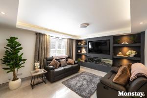 a living room with a couch and a tv at Walled City House in Derry Londonderry