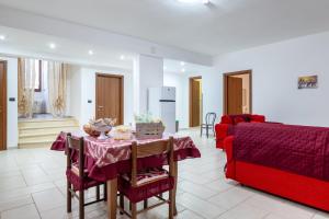 a living room with a table and a red couch at La Perla in Latiano