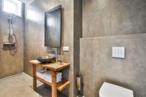 a bathroom with a bowl sink and a shower at Haarlem Hotel Suites in Haarlem +76 photos