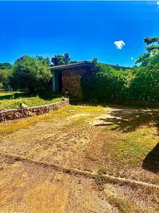 a house sitting on top of a dirt road at Maison agostini in Zonza +9 photos