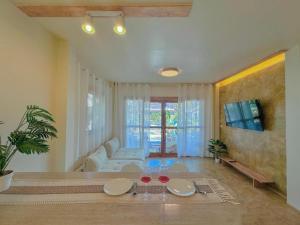 a living room with a table and a couch at Thara Pearl Villa in Ko Phangan