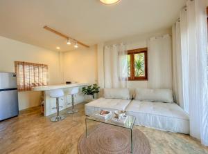 a large living room with a bed and a table at Thara Pearl Villa in Ko Phangan