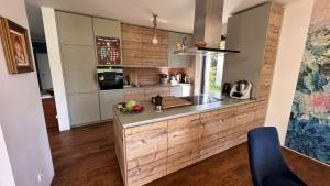 a kitchen with a wooden counter top in a room at Dom przy Panke in Kolonie Röntgental +56 photos