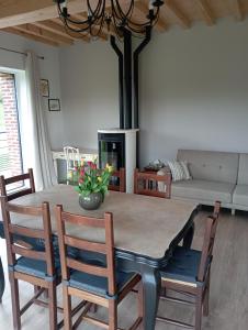 a living room with a table with chairs and a couch at Chambres D'hôtes Les Noisetiers in Saint-Martin-Lestra +37 photos
